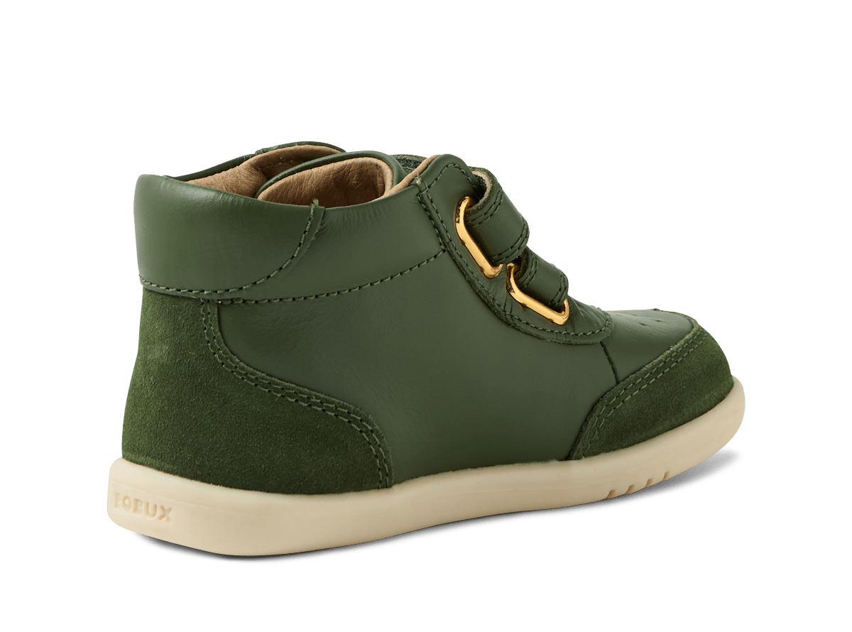 Green children's shoe with gold buckle on a white background