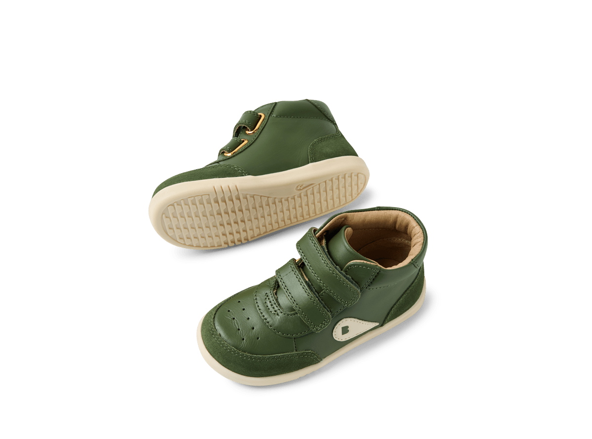 Green children's shoes with velcro straps on a white background