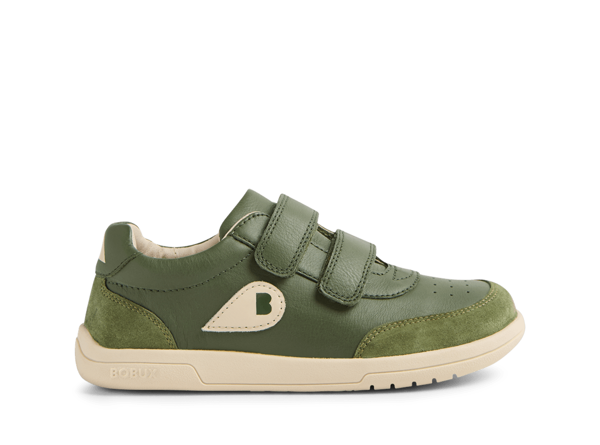 Green children's shoe with velcro straps on a white background