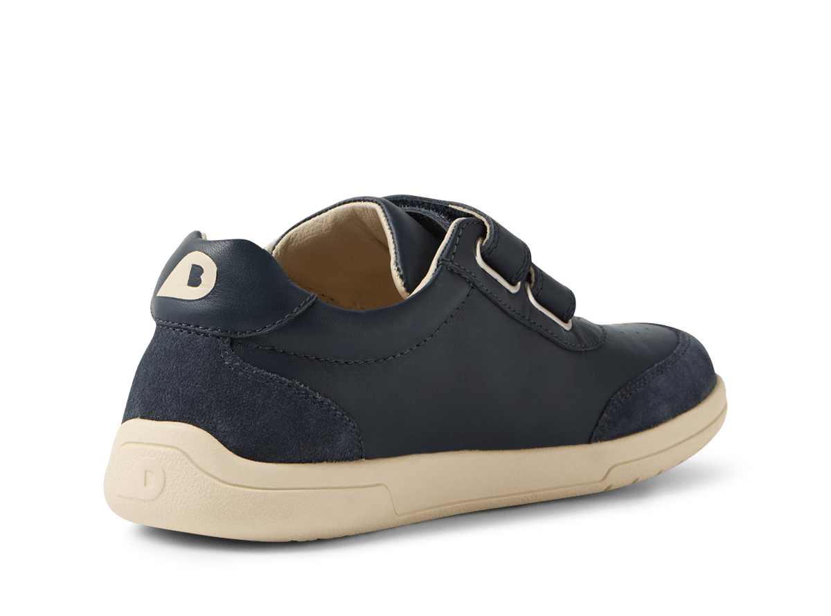 Navy blue children's shoe with a beige sole on a white background