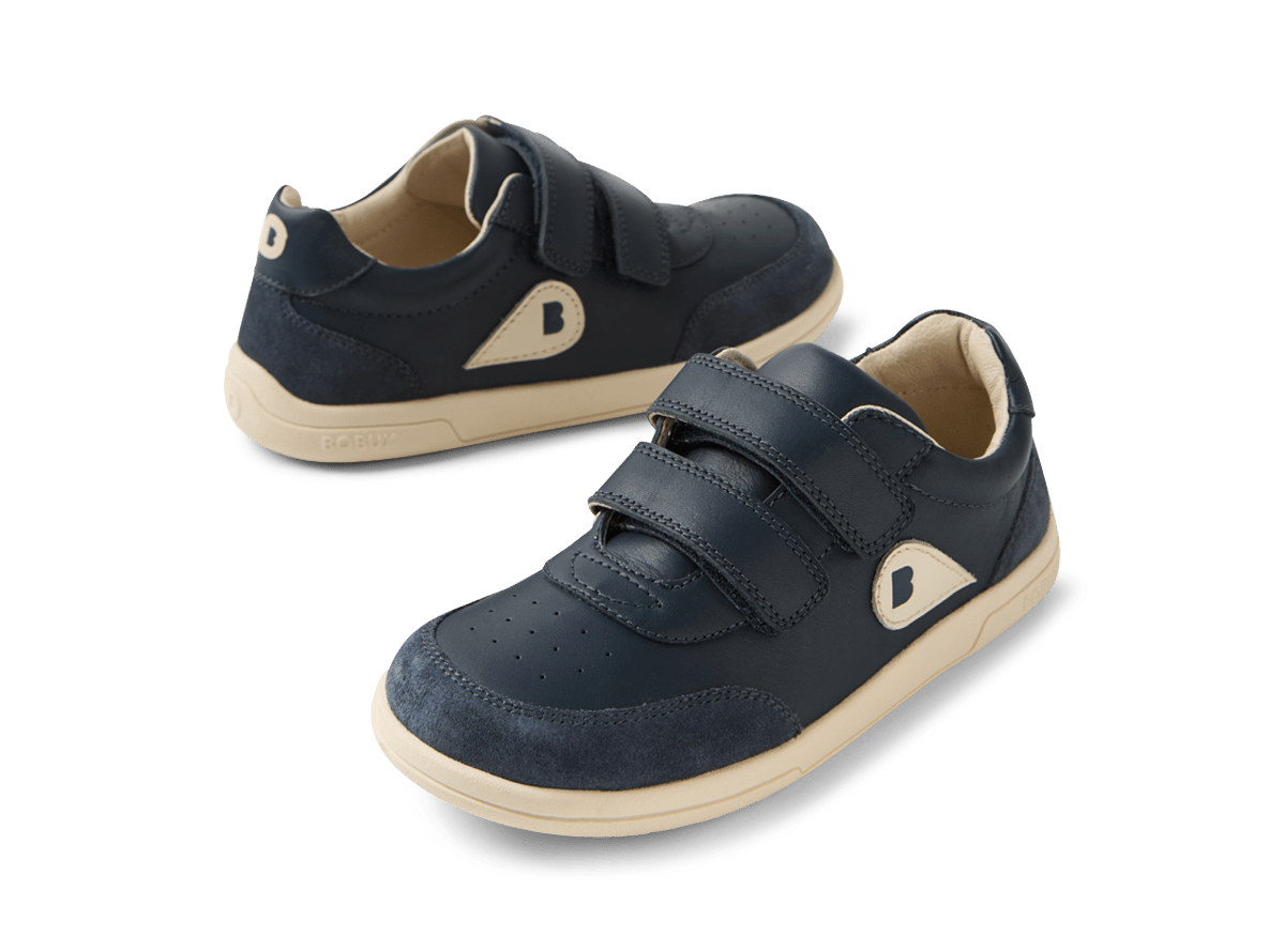 Pair of navy blue children's shoes with velcro straps on a white background
