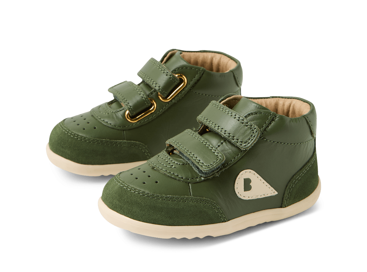 Green children's shoes with velcro straps on a white background