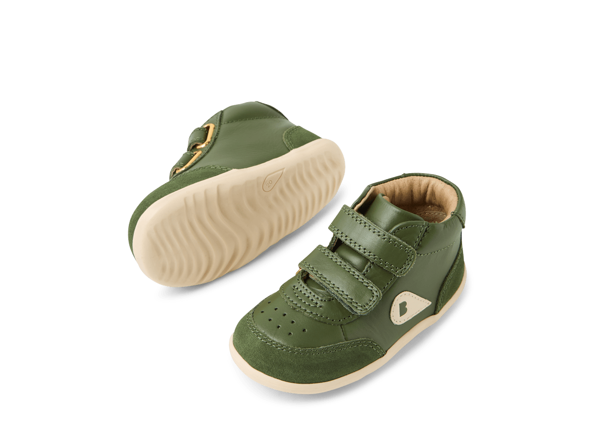 Green baby shoes with velcro straps on a white background