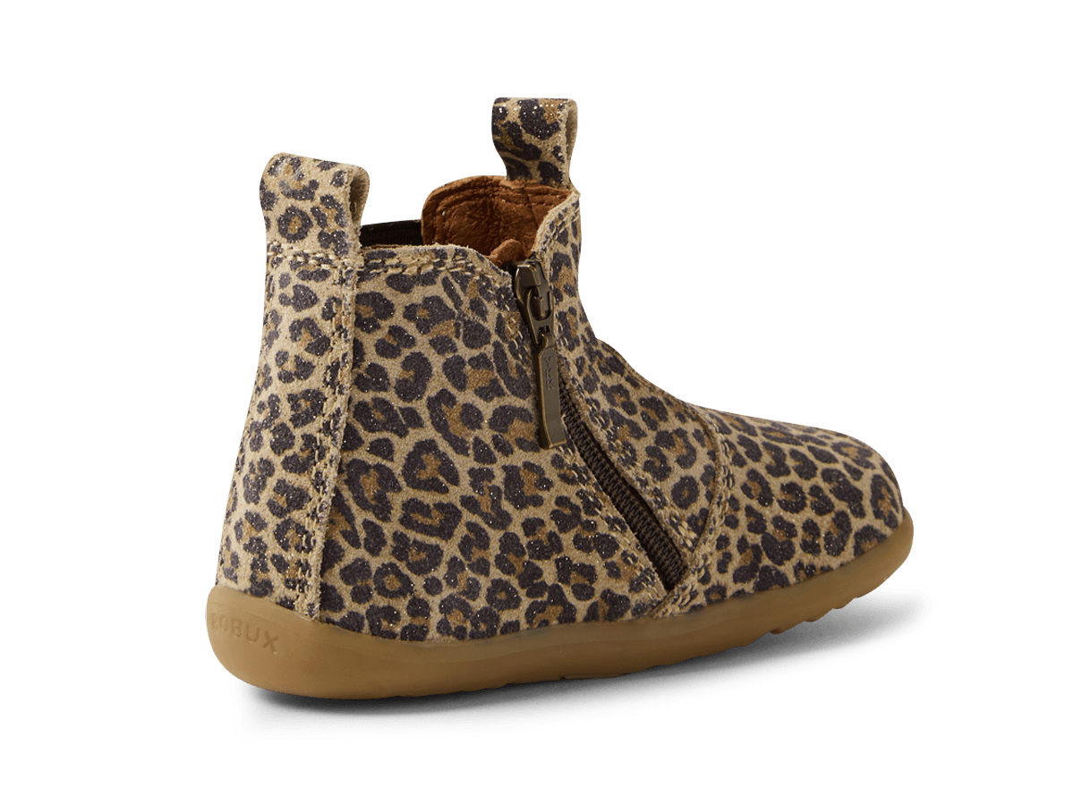 Leopard print boot with brown sole on a white background