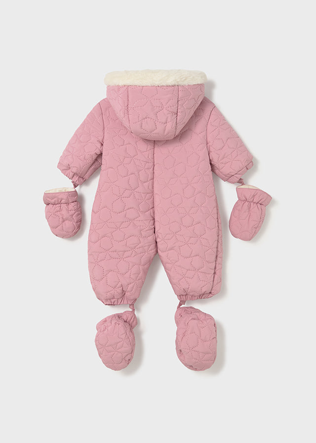 Pink quilted baby snowsuit with matching mittens on a light gray background