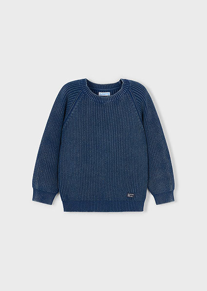 Blue knitted sweater on a light gray background