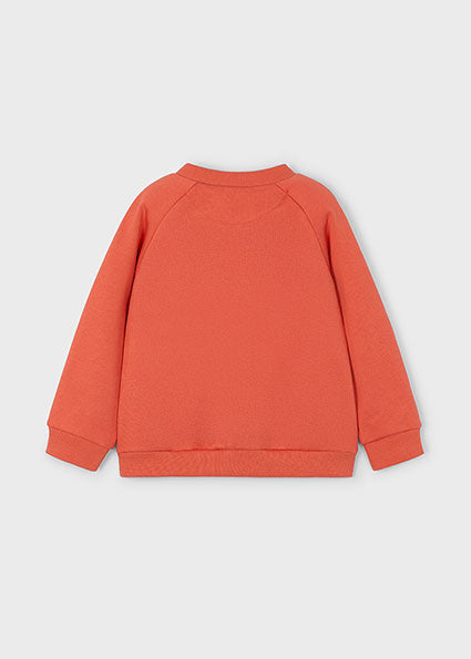 Orange sweatshirt on a light grey background