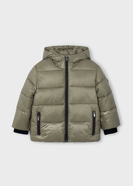 Green puffer jacket with black zippers on a white background