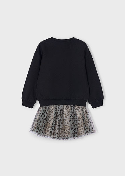 Black sweatshirt with a leopard print skirt on a light grey background