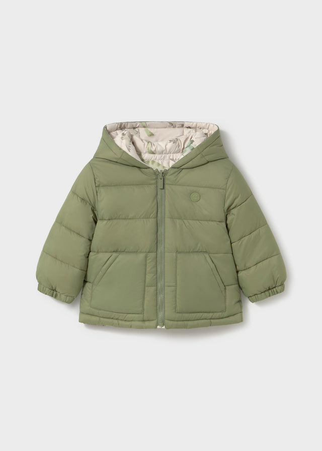 Reversible Bayleaf baby boy hooded coat with quilted green side and cream dinosaur‑print reverse, zip fastening.