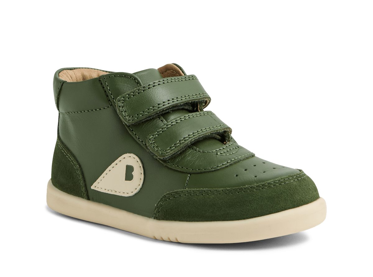 Green children's shoe with velcro straps on a white background