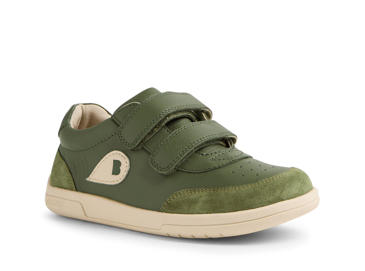 Green children's shoe with velcro straps on a white background