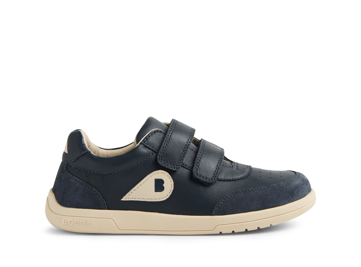 Navy blue children's shoe with a beige sole on a white background