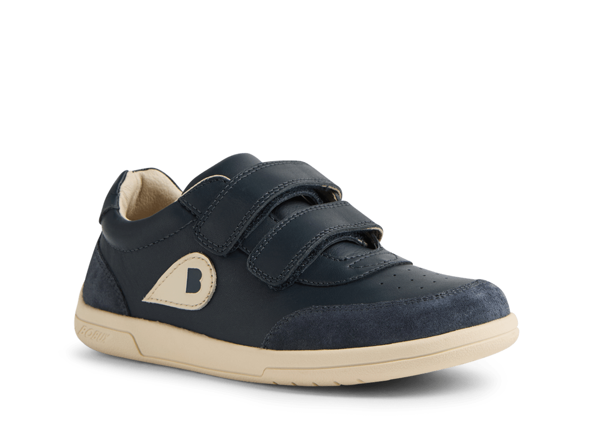 Navy blue children's shoe with velcro straps on a white background