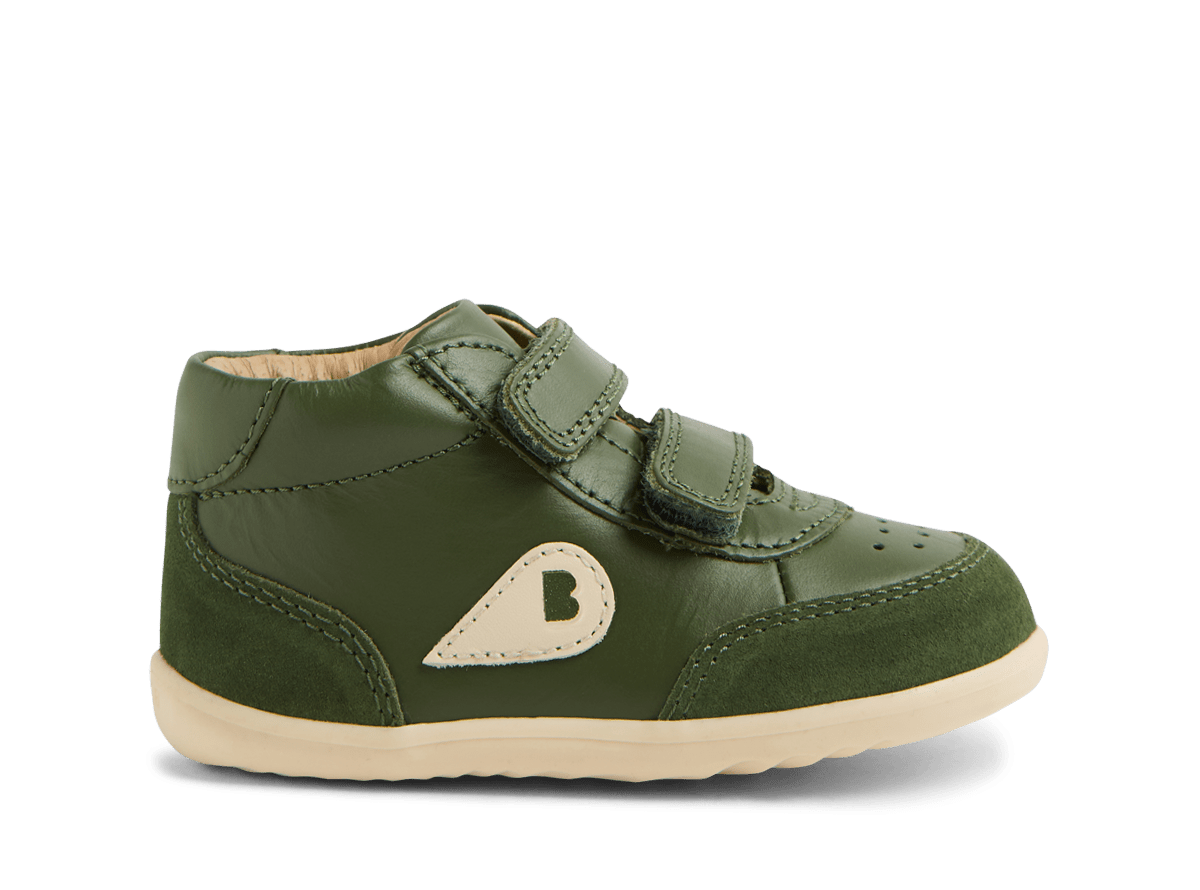 Green children's shoe with a heart logo on a white background