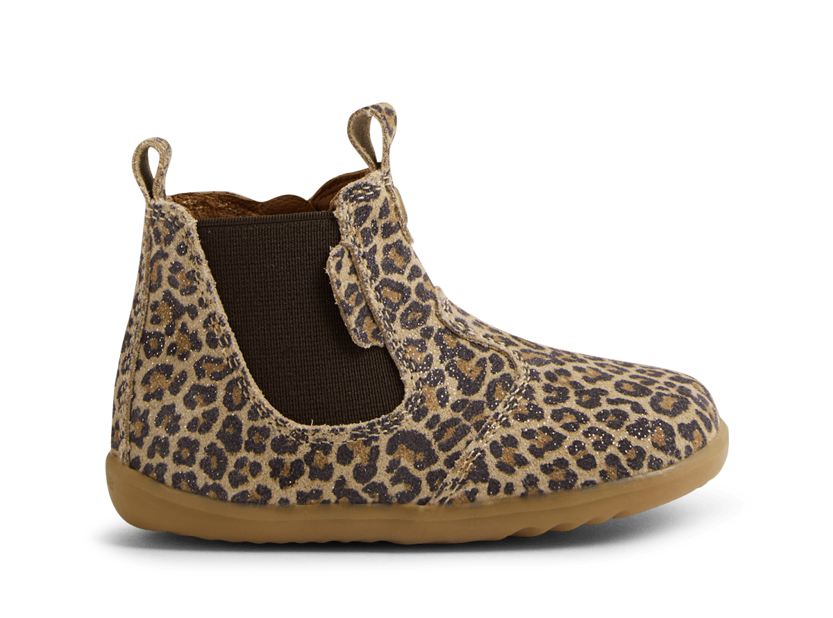 Leopard print boot with brown sole on a white background