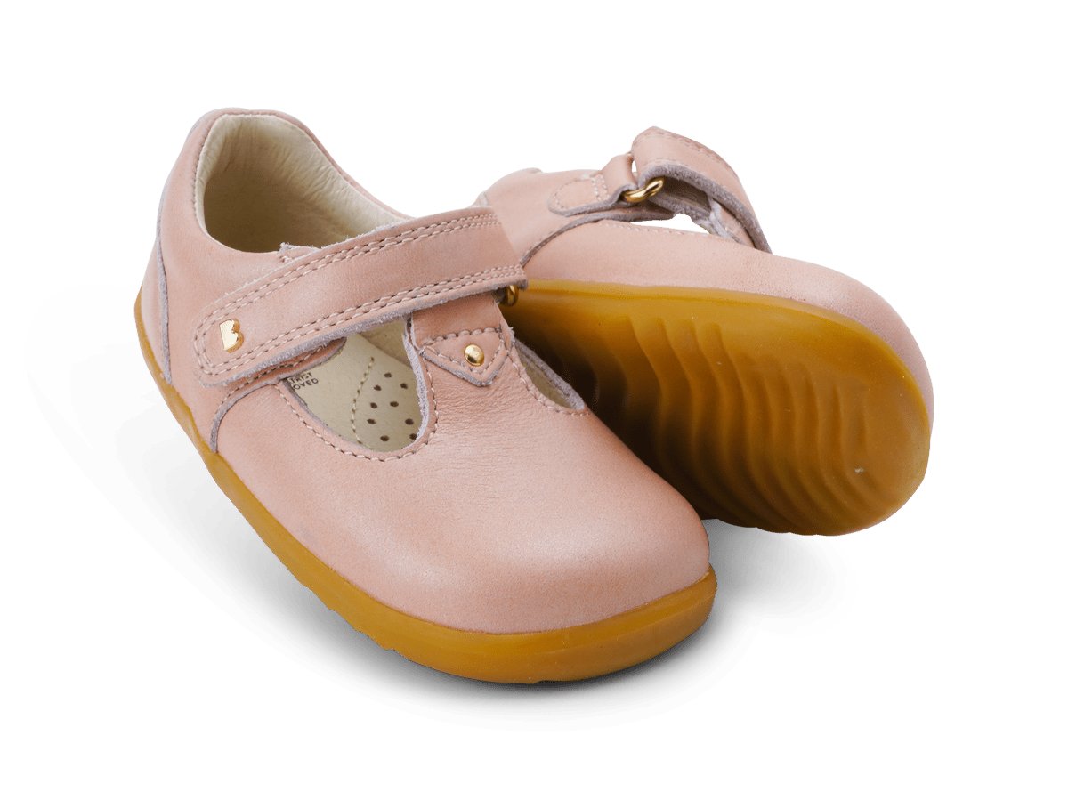 Pair of pink bobux Louise dusk pearl children's shoes with brown soles on a white background
