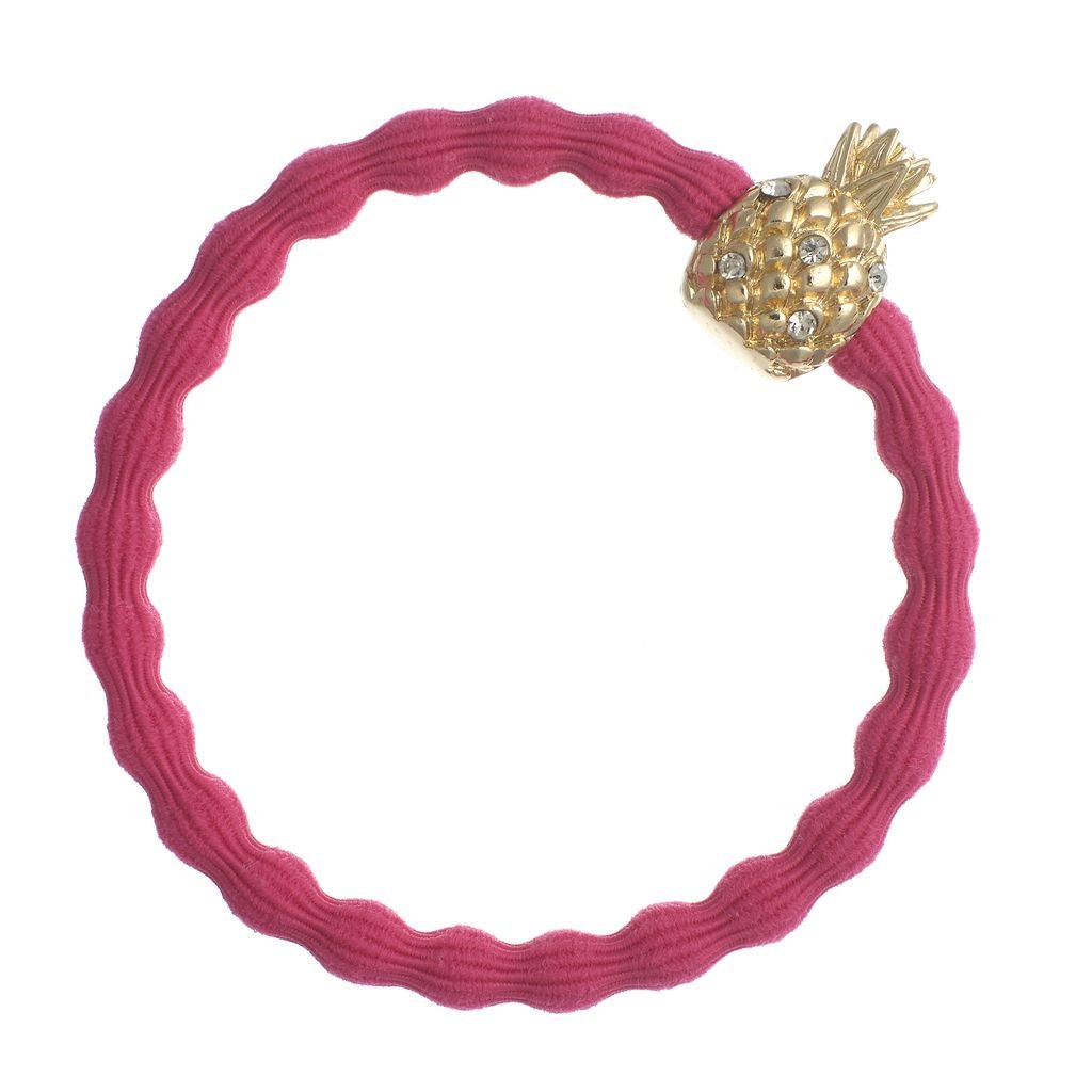 Pink hair tie with a gold pineapple charm on a white background