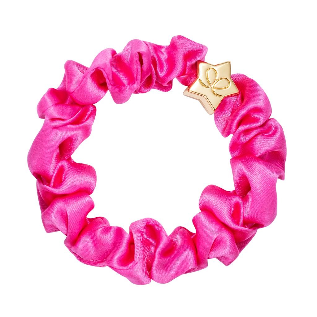 Pink scrunchie with a gold star-shaped clip on a white background