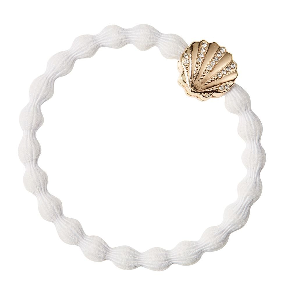 White hair tie with a gold shell-shaped clasp on a white background