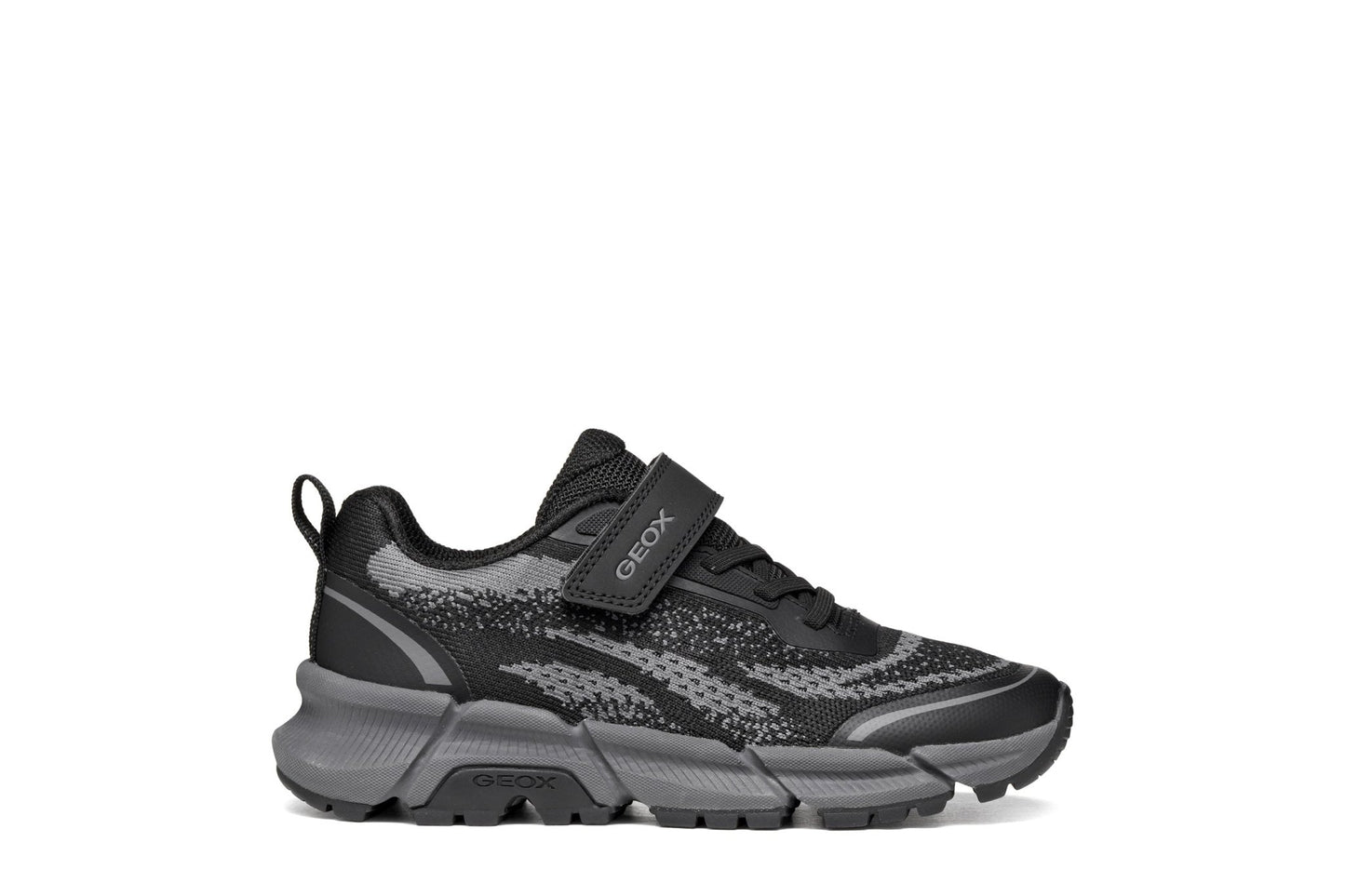 Black and grey Geox Flexyper Plus boys’ trainer with knit‑style upper, elastic laces, Velcro strap and flexible chunky sole.