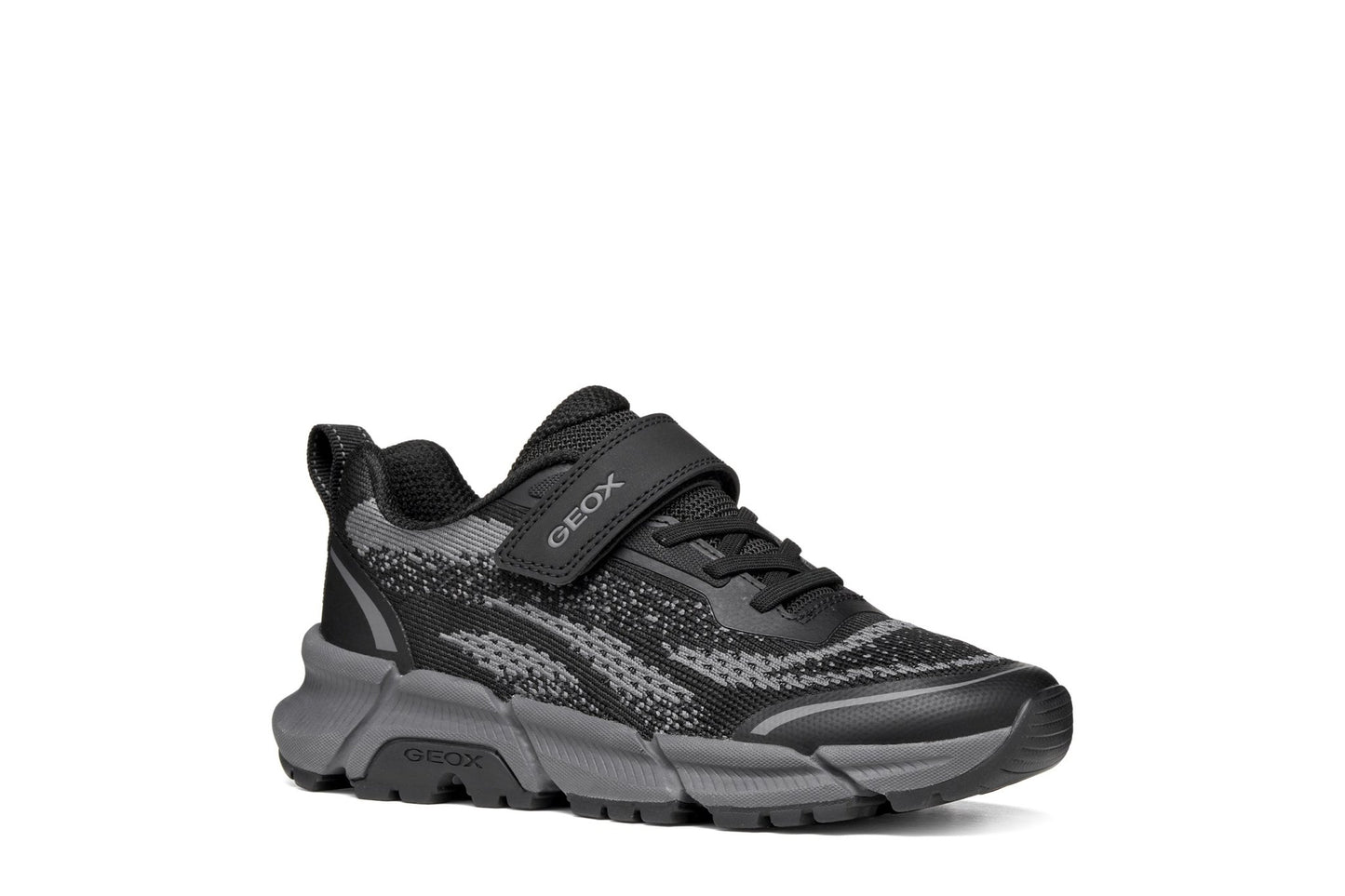 Black and grey Geox Flexyper Plus boys’ trainer with knit‑style upper, elastic laces, Velcro strap and flexible chunky sole.