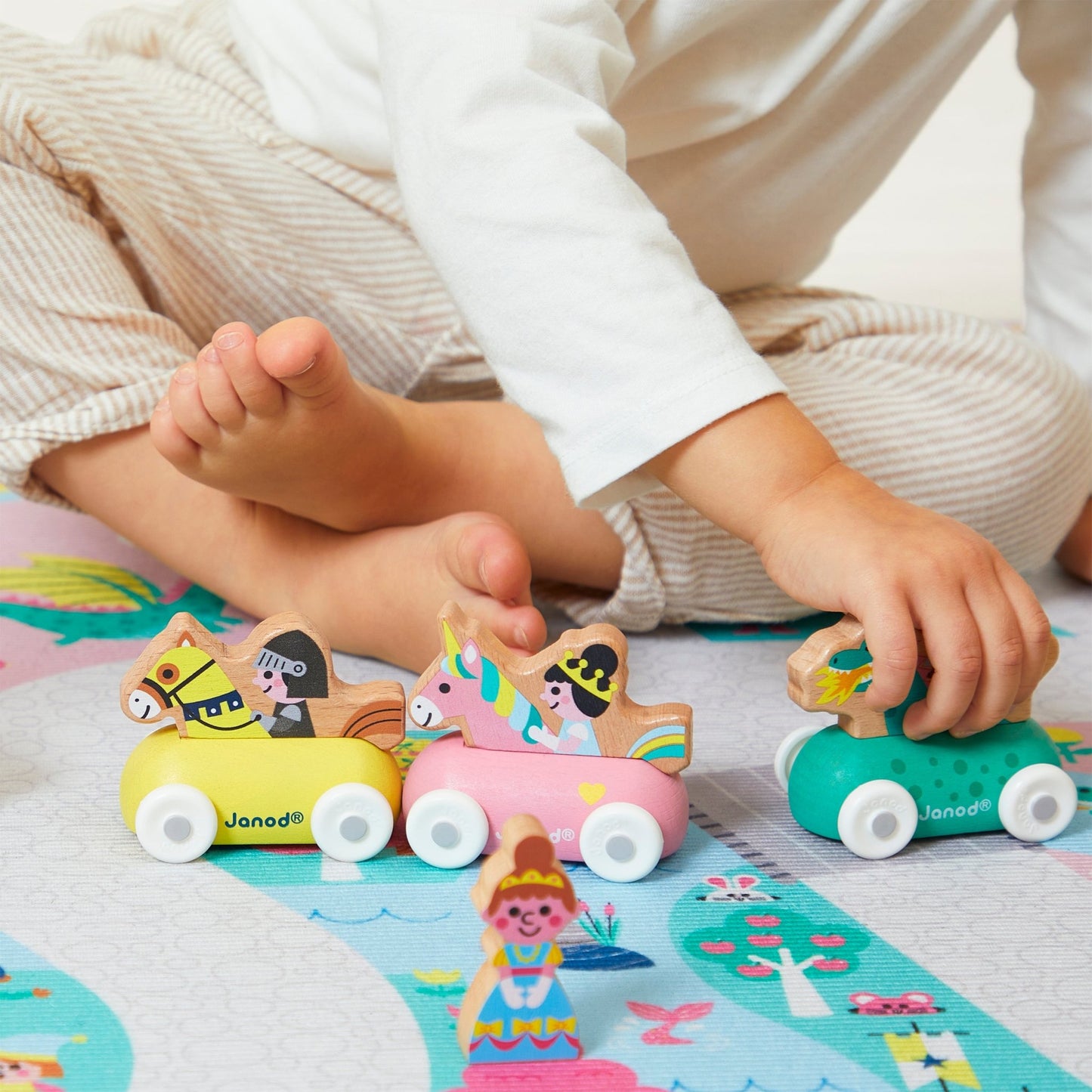 Children playing with colorful wooden toys on a patterned rug