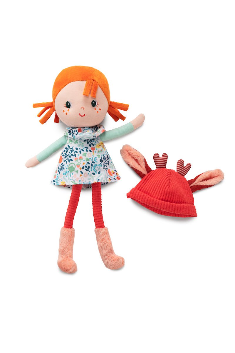 Lilliputiens Stella soft fabric doll with red hair, floral dress, fawn‑ear hat and decorative gift box.