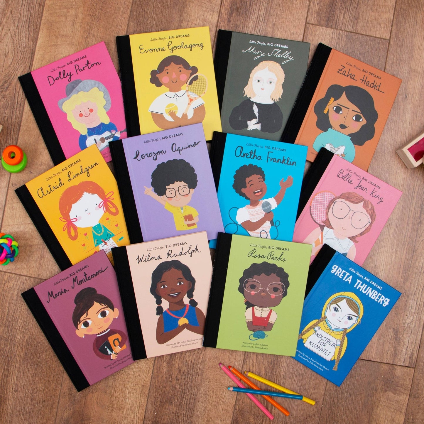 Collection of children's books with illustrated characters on a wooden surface.