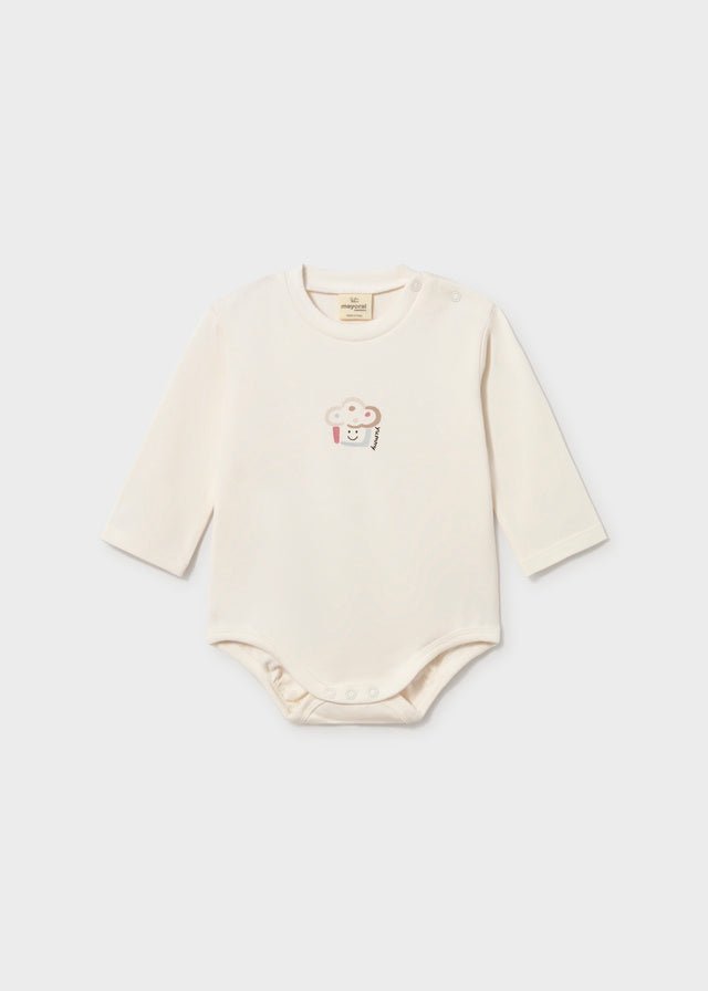 An off-white long-sleeve baby bodysuit with a small embroidered cartoon character on the chest, displayed flat against a light gray background.