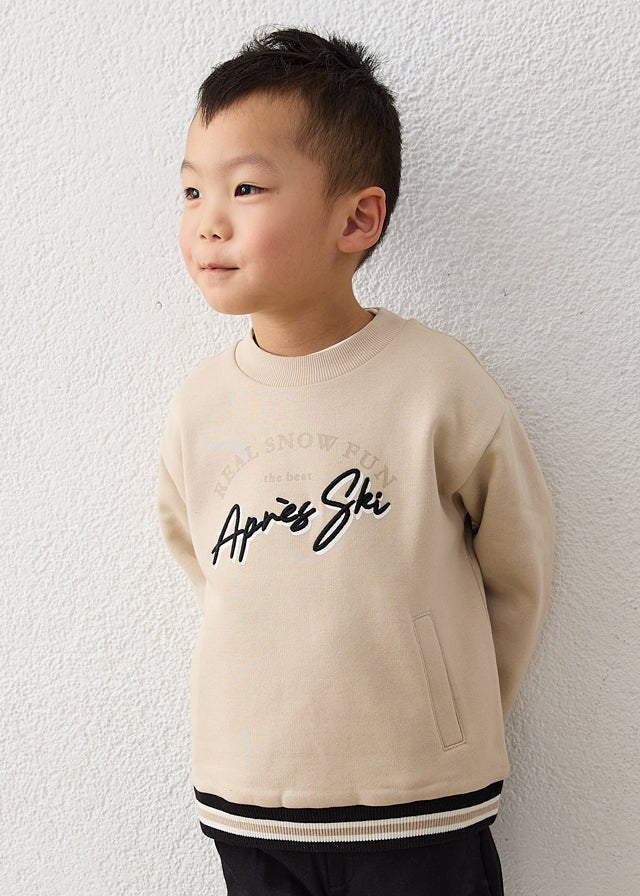 Cream après ski embroidered pullover for boys with soft knit fabric, long sleeves and subtle front embroidery, Style 16‑04462‑078.