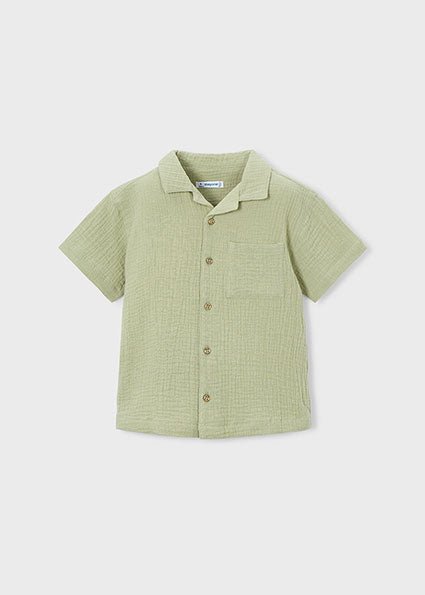 Boy wearing a Mayoral button up cheesecloth style shirt in a bamboo beige colour