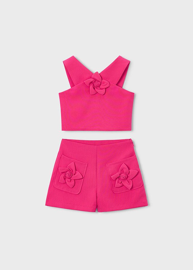 Girls’ bright pink crop‑top and shorts set with wide straps and soft front detail.