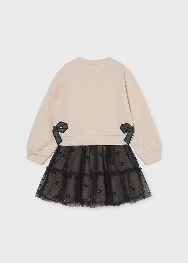 Beige pullover with black bow detail and attached layered black embroidered tulle skirt, Style 16‑04934‑062.