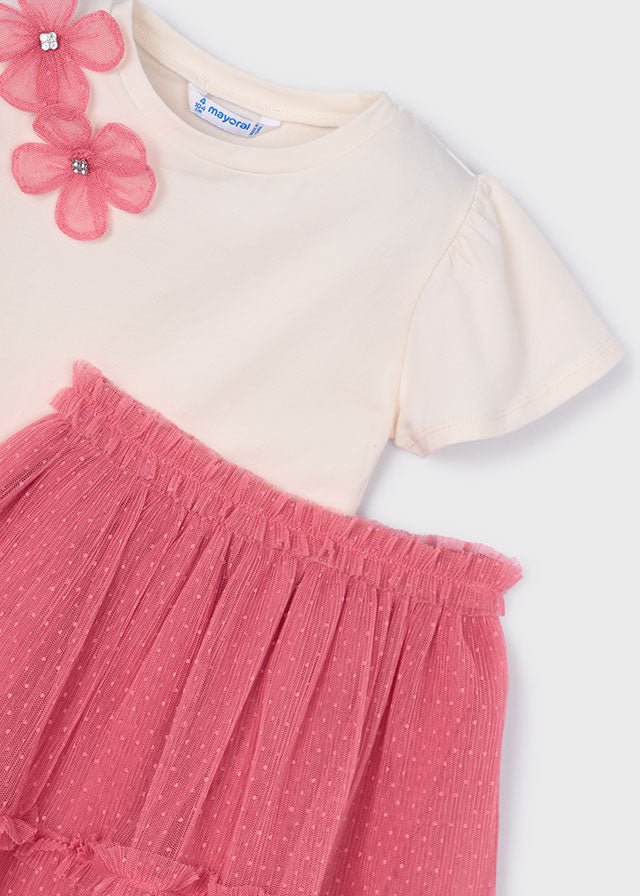Girls’ cream floral‑shoulder top with bright pink layered tulle skirt.