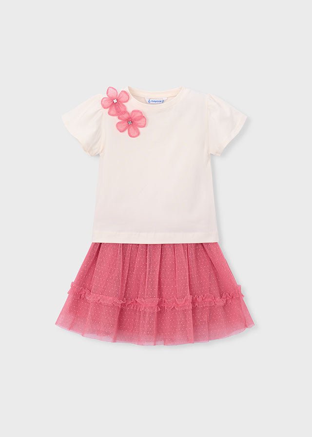 Girls’ cream floral‑shoulder top with bright pink layered tulle skirt.