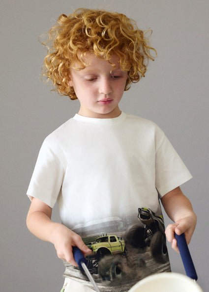 child wearing a white t-shirt with monster truck graphic photo print on