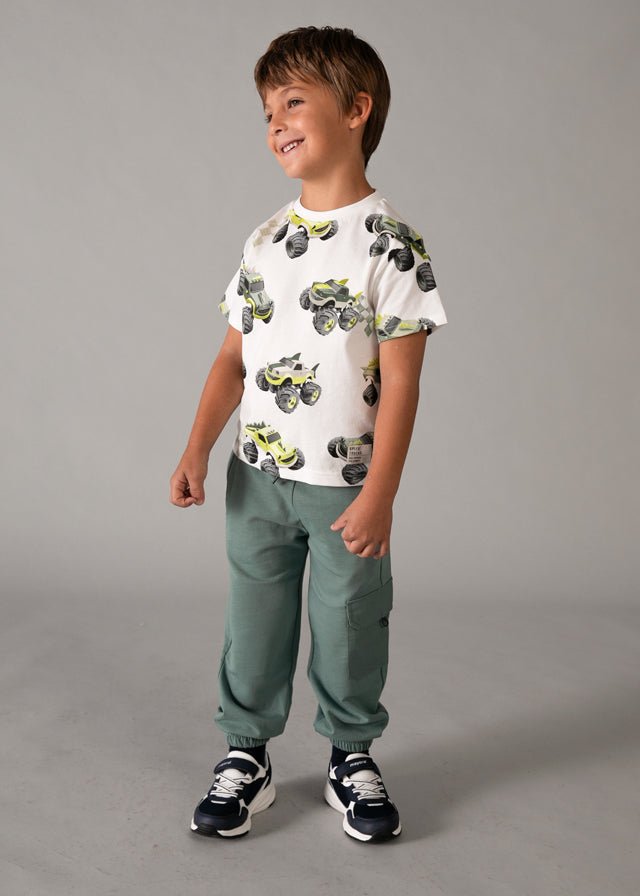 Green jogger pants with elastic waistband, black drawstring, side pockets, and cargo flap pocket, styled for kids’ casual summer wear.