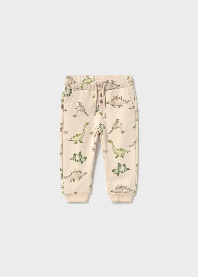 Light Taupe baby trousers with a subtle dinosaur print and long‑leg design.