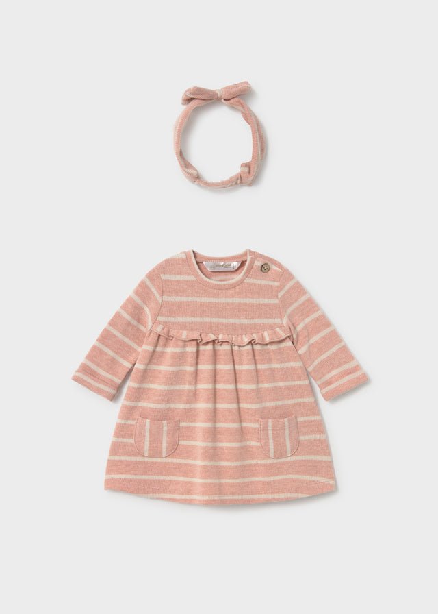 Pink striped dress with a matching headband on a white background