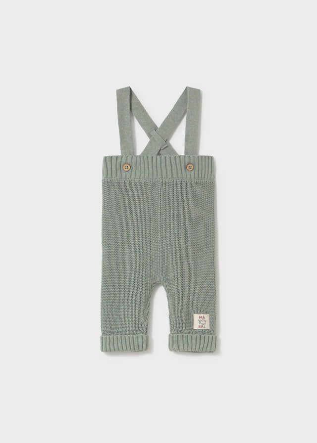 Mayoral baby knit suspenders pants in green — soft cotton trousers with cross‑over straps and button detail.