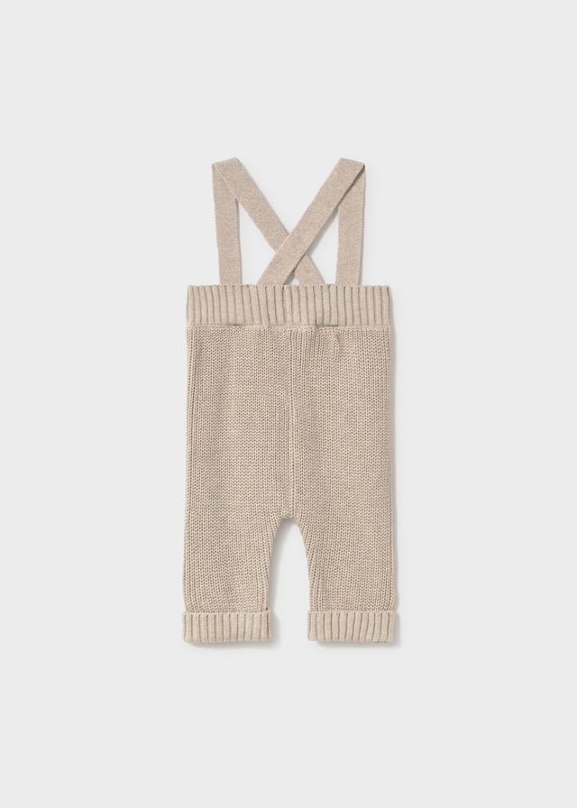 Mayoral baby knit suspenders pants in stone — soft cotton trousers with cross‑over straps and button detail.