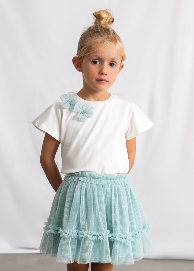 Girls’ white floral‑shoulder top with light blue dotted tulle skirt.