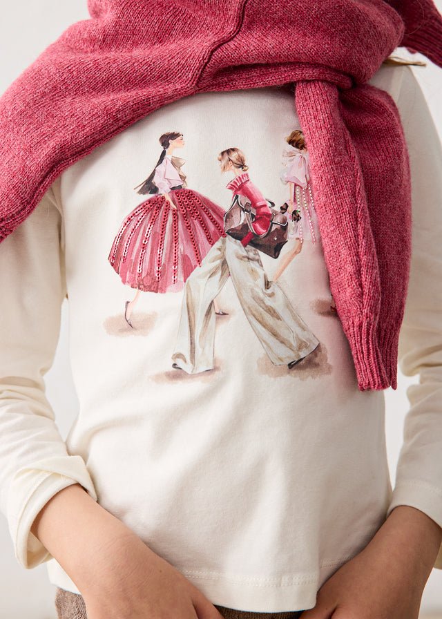 Cotton‑stretch girls cream long sleeve t-shirt with artistic fashion inspired character print.

