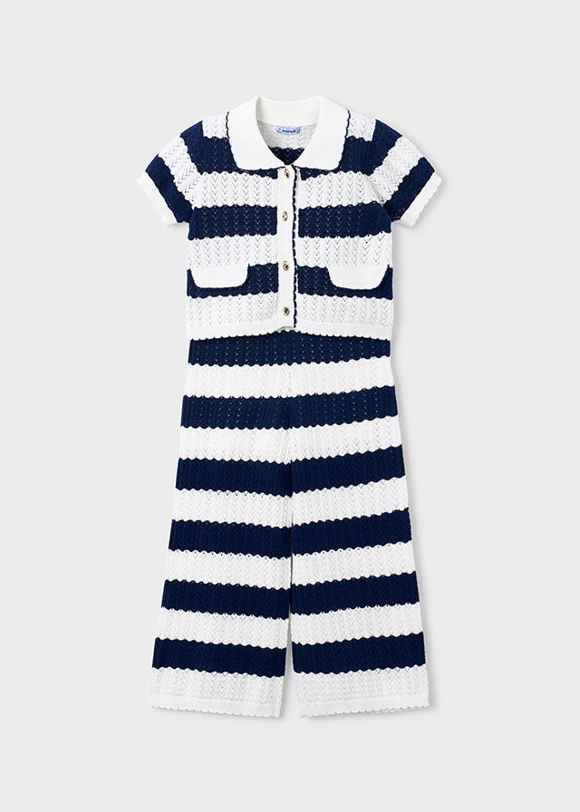 Girls’ two‑piece nautical knit set with navy and white stripes, scalloped texture, white collar, gold buttons, and matching trousers.