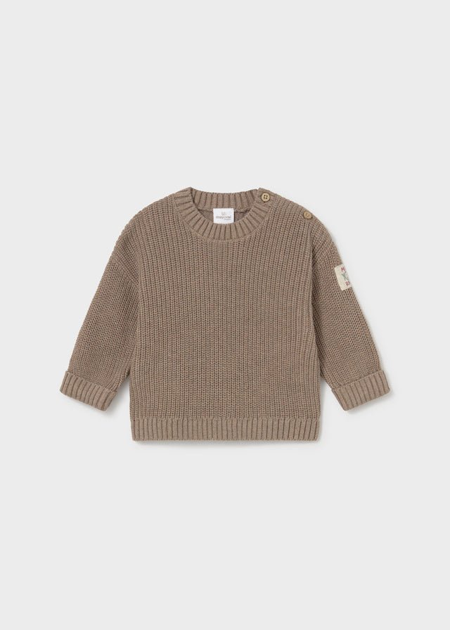 A ribbed knit baby sweater in taupe brown, featuring a crew neck, long sleeves, and small decorative buttons on the shoulders, shown against a light gray background.