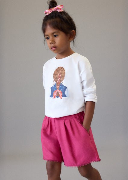 Girls’ bright pink Mayoral summer shorts with elastic waistband, pockets and scalloped lace hem.