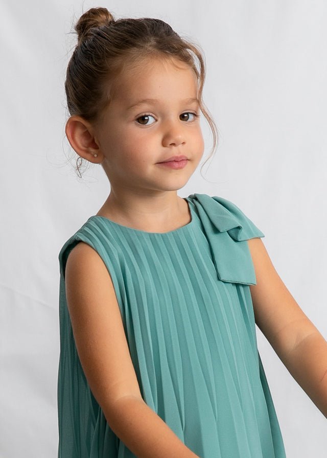 Girls’ teal pleated dress with bow‑shoulder detail, sleeveless and lightweight.