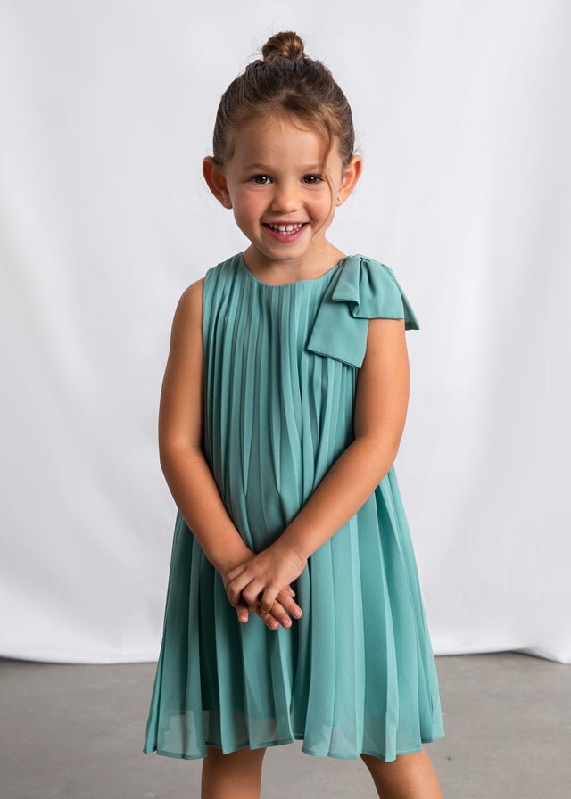 Girls’ teal pleated dress with bow‑shoulder detail, sleeveless and lightweight.