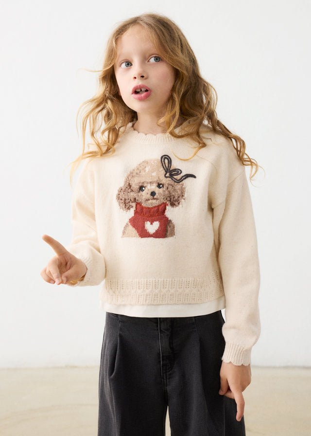 Child wearing a cream sweater with a dog design on a white background